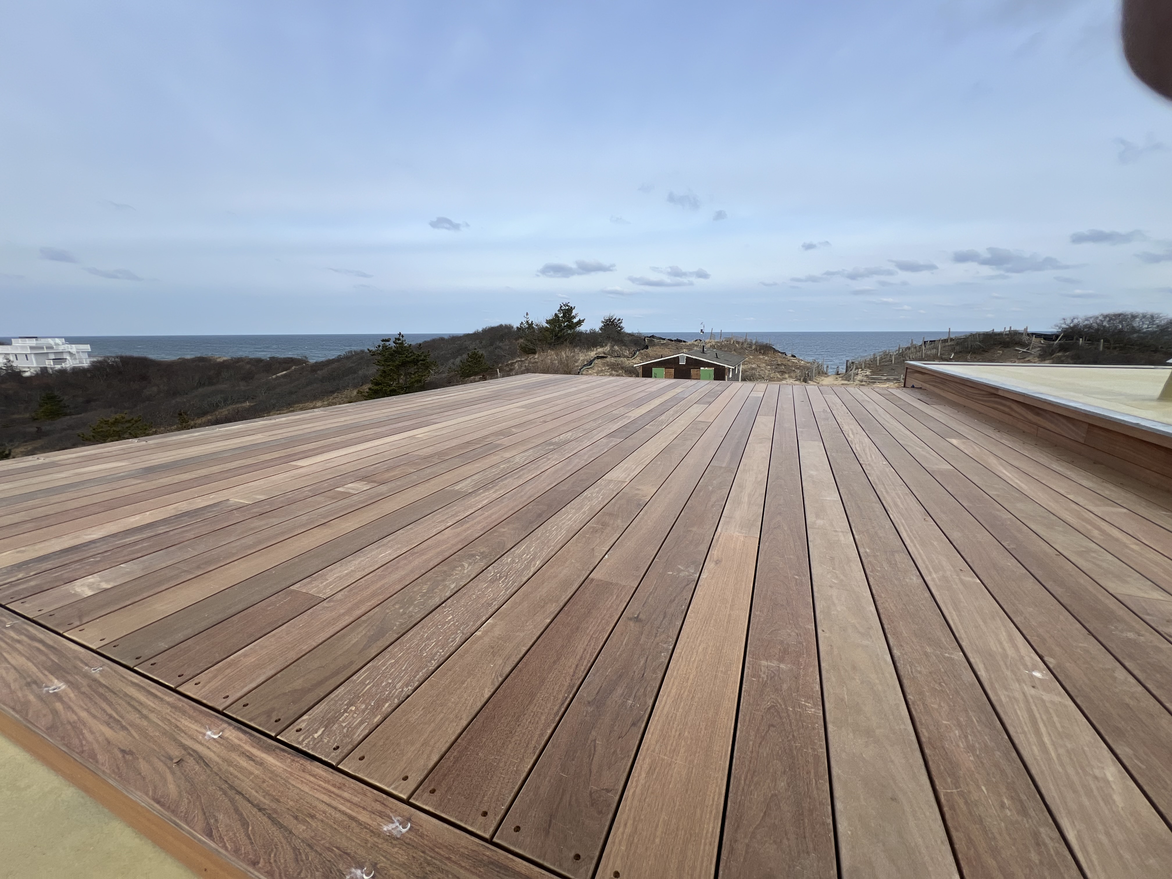 Deck surface with ocean view beyond the railing.