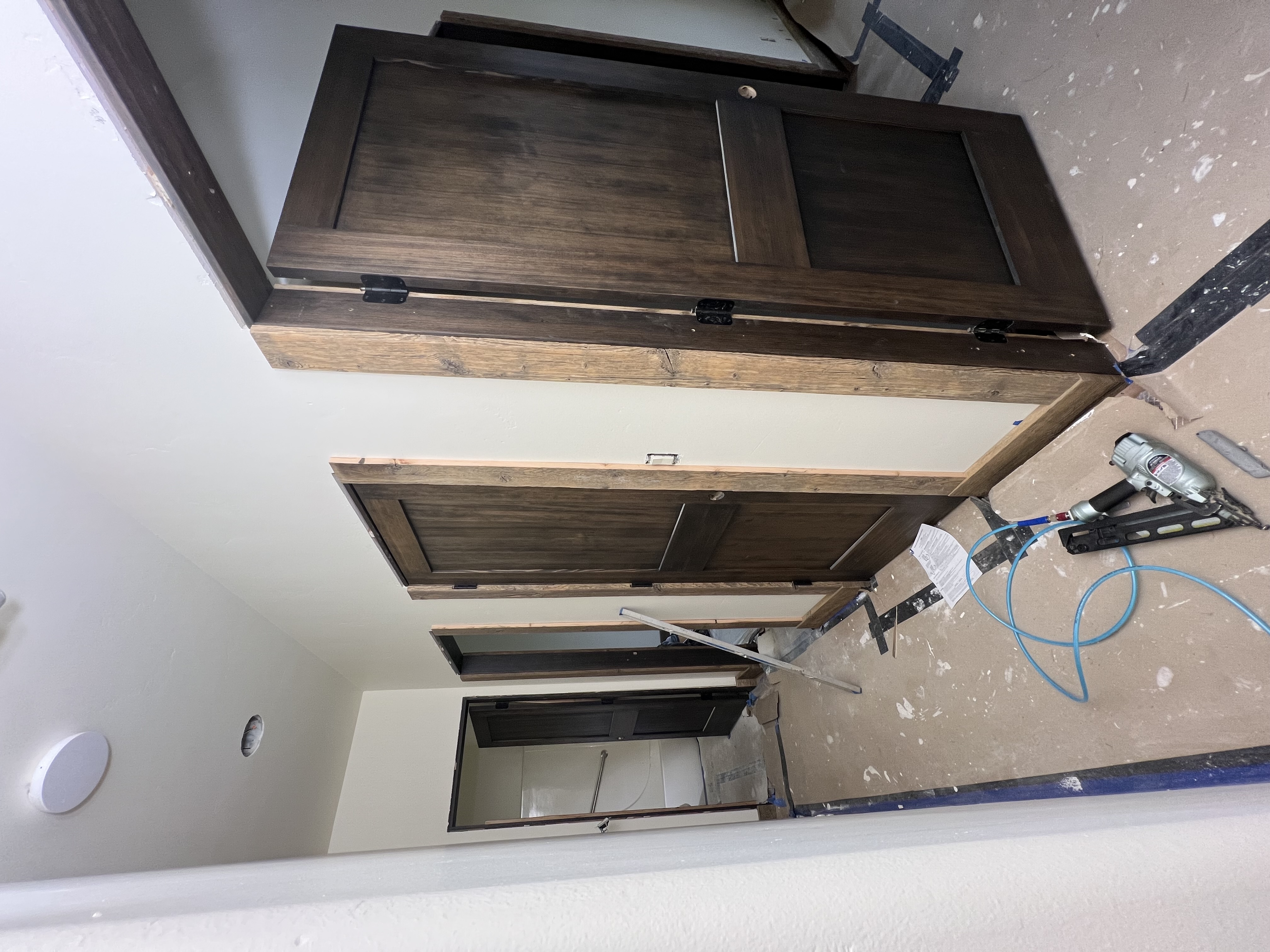 Interior hallway trim and door installation in progress.